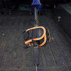 Black and orange baitcaster fishing reel protective cover